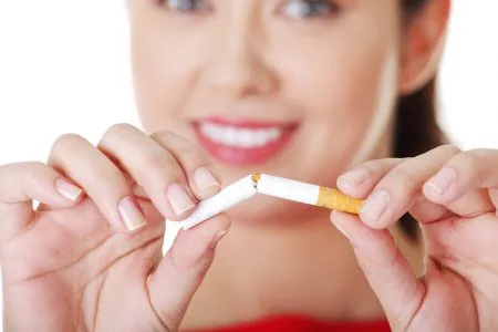 woman breaking a cigarette in half
